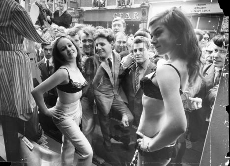 Centre of attention: Semi-clad models at a London boutique in the Sixties